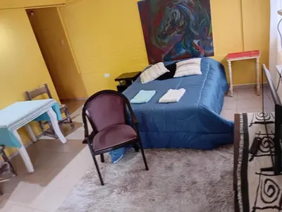 a room with a couch and a chair and a table at Monoambiente Alto Verde in Cordoba