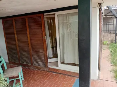 a porch with a sliding glass door and a window at Monoambiente Alto Verde in Cordoba