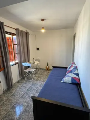 a bedroom with a bed and a table and chairs at Depto Quality in Cordoba