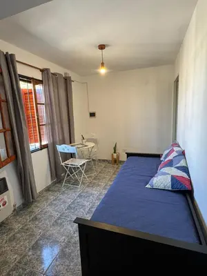 a bedroom with a bed and a table in it at Depto Quality in Cordoba