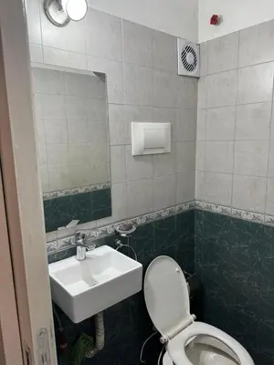 a bathroom with a sink and a toilet and a mirror at Depto Quality in Cordoba