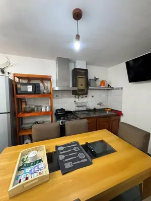 a kitchen with a wooden table with a counter top at Depto Quality in Cordoba