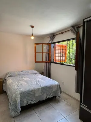 a bedroom with a bed and a window at Depto Quality in Cordoba