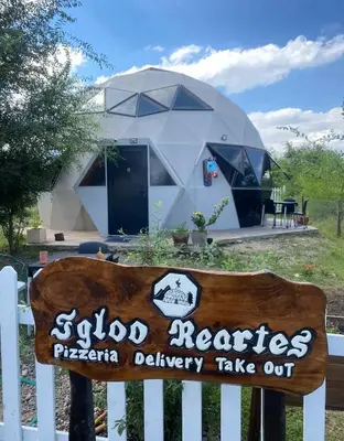 a round house with a sign in front of it at Domo Del Rio in Los Reartes