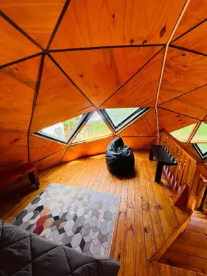 a large room with a large window in a yurt at Domo Del Rio in Los Reartes