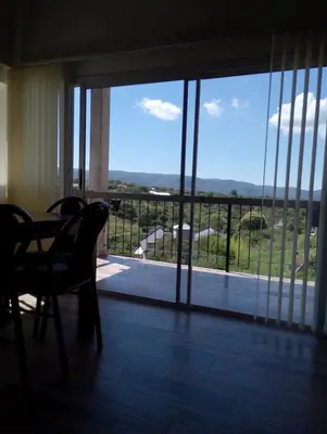 a room with a table and chairs and a large window at Cabaña Siegfried in Villa General Belgrano