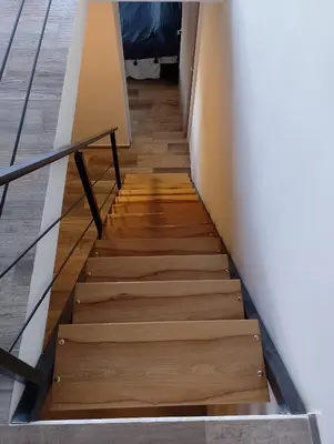 a stairwell in a house with wooden stairs at Cabaña Siegfried in Villa General Belgrano