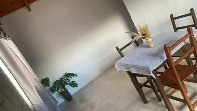 a dining room with a table and two chairs at Cabaña Carmanqui in Alpa Corral