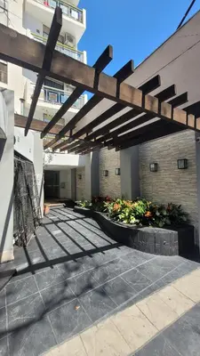 awning over a courtyard in a building with flowers at Depto Centro con Patio Pet Friendly La Cañada in Cordoba