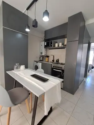 a kitchen with a white table with a keyboard on it at Central y confortable departamento in Cordoba