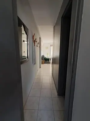 a hallway with a tile floor and an open door at Central y confortable departamento in Cordoba