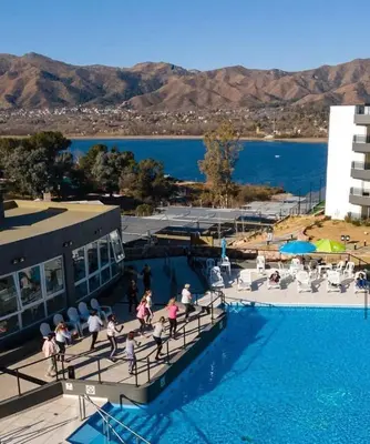a group of people walking around a swimming pool at Veneto Village in Villa Parque Siquiman
