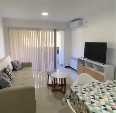 a living room with a couch and a table and a tv at Veneto Village in Villa Parque Siquiman