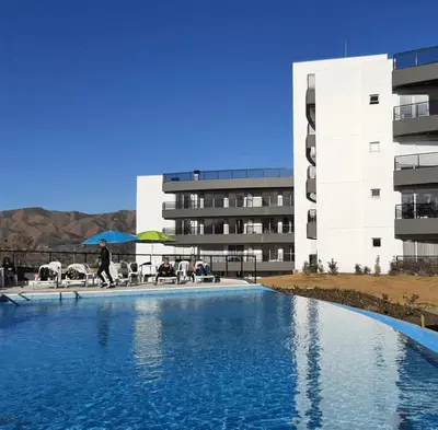 a large swimming pool in front of a building at Veneto Village in Villa Parque Siquiman