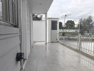 a porch of a white house with a white door at refugio Bv los andes in Cordoba