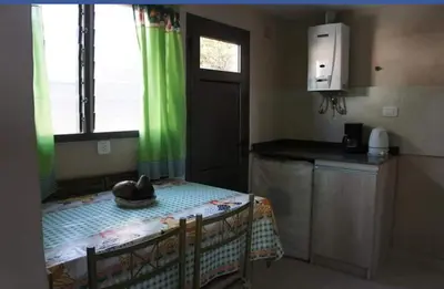 a small kitchen with a table with a hat on it at La tranquera Carlos Paz in Villa Carlos Paz