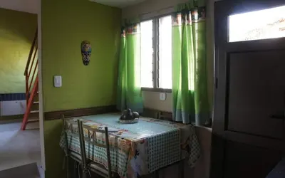 a room with a crib in a room with green walls at La tranquera Carlos Paz in Villa Carlos Paz