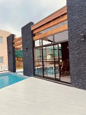 a villa with a swimming pool and a house at Por Amor a Norma in Potrero de Garay