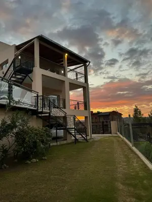 a large building with a sunset in the background at Por Amor a Norma in Potrero de Garay