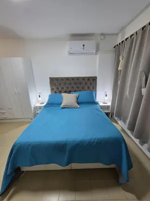 a bedroom with a blue bed with a blue blanket at Monoambiente cómodo zona centro in Cordoba