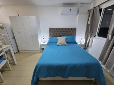 a bedroom with a blue bed with a pillow on it at Monoambiente cómodo zona centro in Cordoba