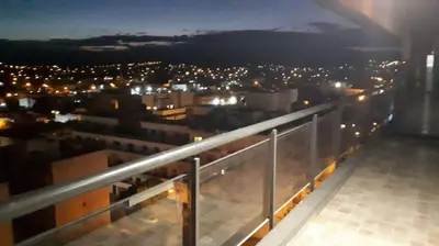 a view of a city at night from a balcony at Miralejos 7 in Villa Carlos Paz