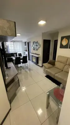 a living room with a couch and a dining room at Miralejos 7 in Villa Carlos Paz