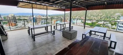 a room with two tables and a view of a city at Miralejos 7 in Villa Carlos Paz