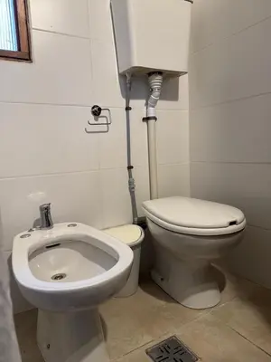 a bathroom with a toilet and a bidet at Stanza Córdoba, Heriberto Martinez, Villa Belgrano in Cordoba
