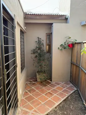 an empty entryway to a house with a plant at Stanza Córdoba, Heriberto Martinez, Villa Belgrano in Cordoba