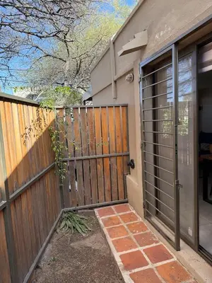 a house with a wooden gate and a fence at Stanza Córdoba, Heriberto Martinez, Villa Belgrano in Cordoba