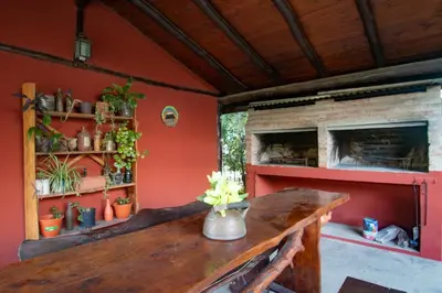 a room with a wooden table and a fireplace at La Casona Cabañas in Villa Ciudad Parque