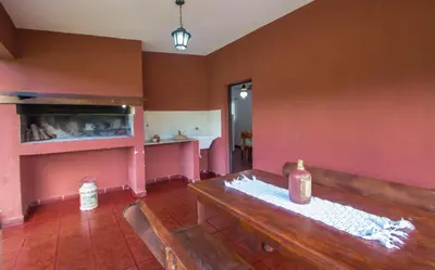 a room with a wooden table and a bottle on it at La Casona Cabañas in Villa Ciudad Parque