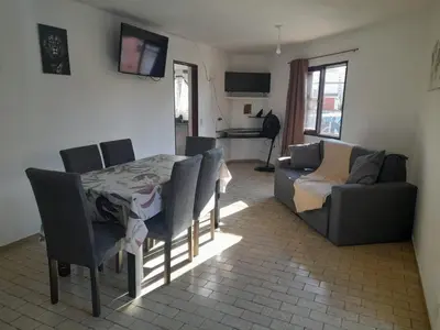 a living room with a table and chairs and a couch at Apartamento LEO-BEL in Cordoba