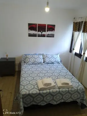 a bedroom with a bed with two towels on it at Apartamento LEO-BEL in Cordoba