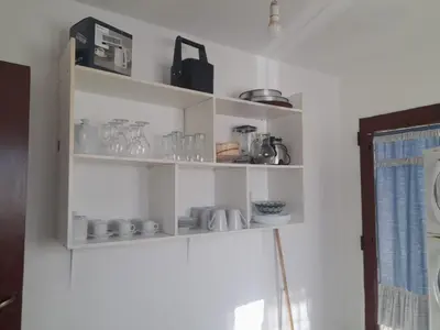 a shelf with cups and other items on it at Apartamento LEO-BEL in Cordoba