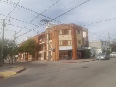 a building on the corner of a street with a car at Apartamento LEO-BEL in Cordoba