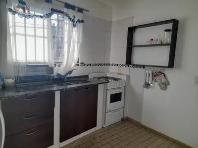 a kitchen with a stove and a sink and a window at Apartamento LEO-BEL in Cordoba