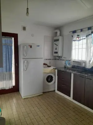 a kitchen with a white refrigerator and a washing machine at Apartamento LEO-BEL in Cordoba