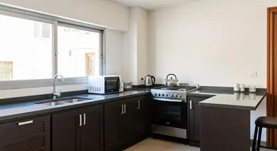 a kitchen with a sink and a microwave at Depto cómodo en Nueva Córdoba in Cordoba