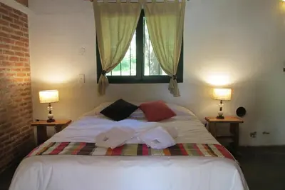 a bedroom with a bed with towels on it at Estancia san Miguel in San Miguel de los Rios