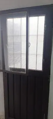 a door with two windows in a room at Departamento sol in Cordoba