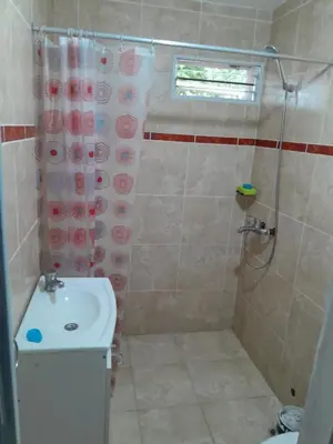 a bathroom with a shower and a toilet and a sink at hogar entre montañas in Santa María