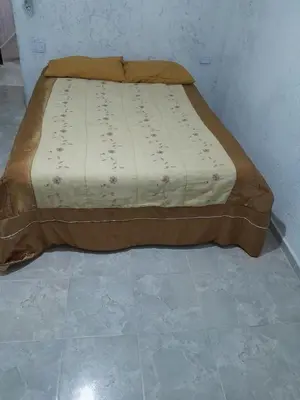 a bed sitting on a tiled floor in a room at hogar entre montañas in Santa María