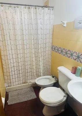 a bathroom with a toilet and a sink at Gral paz Dpto completo con cama queen y seguridad in Cordoba