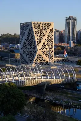 a bridge over a river with a building at Gral paz Dpto completo con cama queen y seguridad in Cordoba