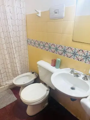 a bathroom with a toilet and a sink at Gral paz Dpto completo con cama queen y seguridad in Cordoba
