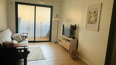 a living room with a couch and a television at Excelente Departamento Nueva Córdoba in Cordoba