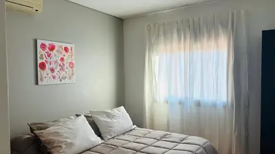 a bedroom with a couch and a window at Excelente Departamento Nueva Córdoba in Cordoba