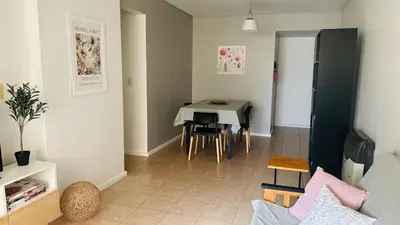 a living room with a table and chairs at Excelente Departamento Nueva Córdoba in Cordoba
